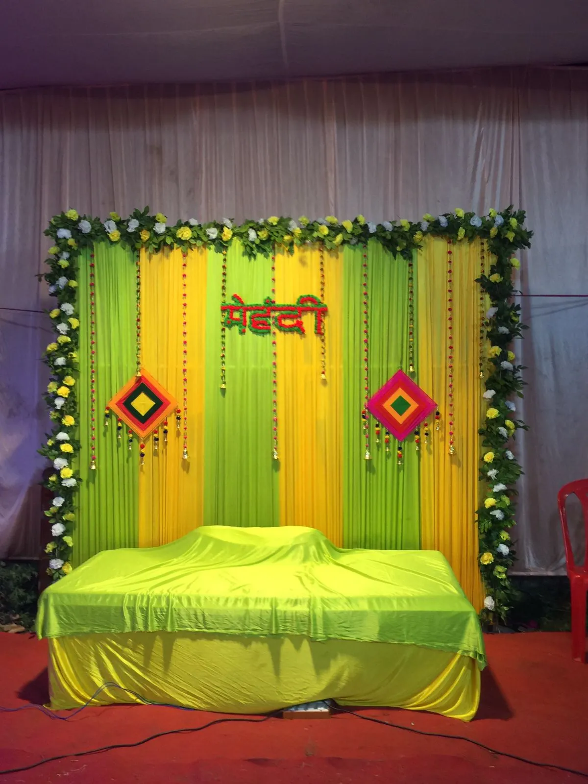 Mehendi ceremony decoration with traditional Indian decor